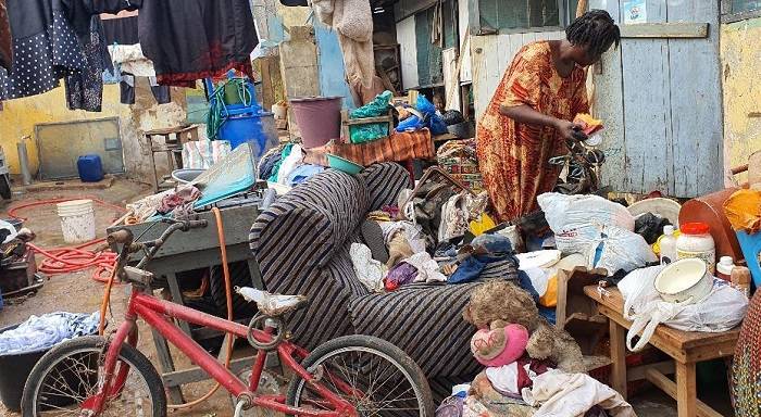 An affected person sorting out destroyed items.Photo Godwin Ofosu-Acheampong