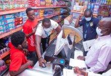 Officials of GRA checking the POS system of one of the businesses
