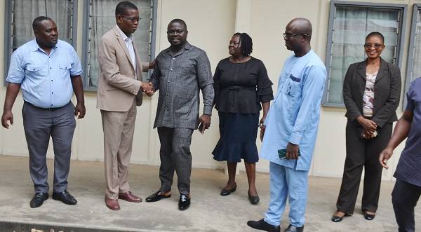 Mr David Agbenu (second from left) interacting with Mr Albert Dwumfour (fourth from right). With them are management members of NTC. Photo Godwin Ofosu-Acheampong.