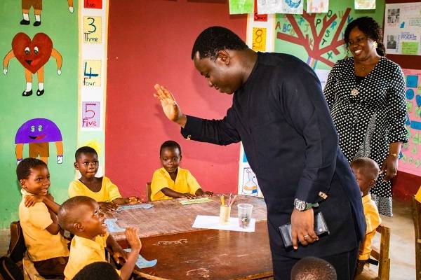 Rev John Ntim Fordjour interacting with some of the pupils