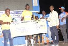 Tagoe (second left) receiving his prize from organisers