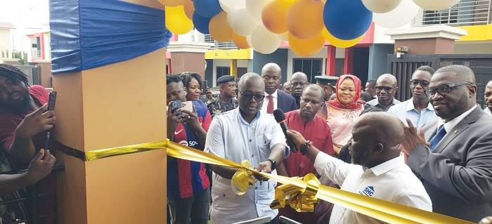 • Mr Assenso-Boakye (left) cuts the tape to inaugurate the building. With him are Mr Kwabena Ampofo-Appiah (in suit) and other dignitaries