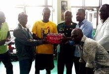 • Ibrahim Issaka (third right) presenting the items to Black Bombers captain, Abdul Wahid Omar (third left), and Head Coach, Ofori Asare (second left)