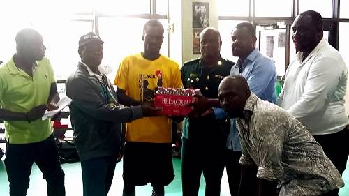 • Ibrahim Issaka (third right) presenting the items to Black Bombers captain, Abdul Wahid Omar (third left), and Head Coach, Ofori Asare (second left)
