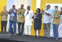 • Dignitaries applauding after Mr Kwabena Agyekum (middle) inagurated the buildings (inset) Photo: Godwin Ofosu-Acheampong