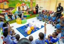Mrs Samira Bawumia and Ms Alison Tweed (facing the children) interacting with them