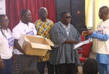 • Dr Obeng-Asamoa receiving the white canes from the lecturer