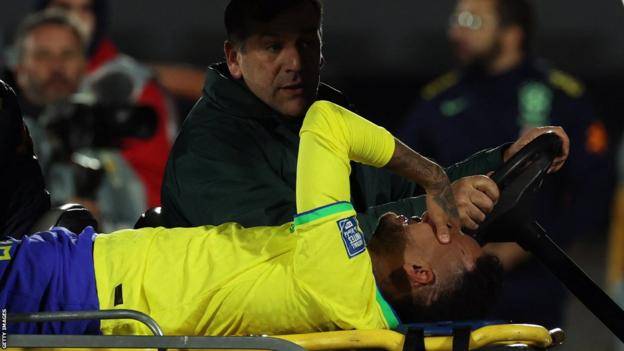A tearful Neymar leaving the pitch on a stretcher
