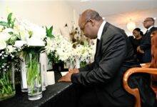 Dr Addison sign the book of condolence