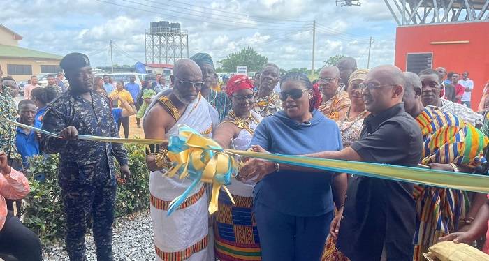 Mrs Asiamah-Adjei (second from right) cutting a tape to inaugurate the facility with the support of Mr Razaaly (right) and some traditional leaders
