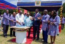 President Akufo-Addo(middle) being assisted by other dignitaries to cuts the anniversary cake
