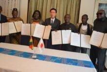 Mr Mochizuki Hisanobu(middle) and beneficiareis with the signed document Photo Godwin Ofosu-Acheampong