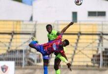 Joseph Mereku and Adams Sanut (in green) in an aerial tussle for the ball Photo Raymond Ackumey