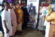 Prophet Ansah being assisted to unveil the anniversary logo