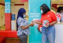 Ms Mansah-Poku introducingTOBi to a Vodafone customer