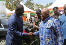 President Akufo-Addo (right) in a handshake with Dr Bryan Acheampong