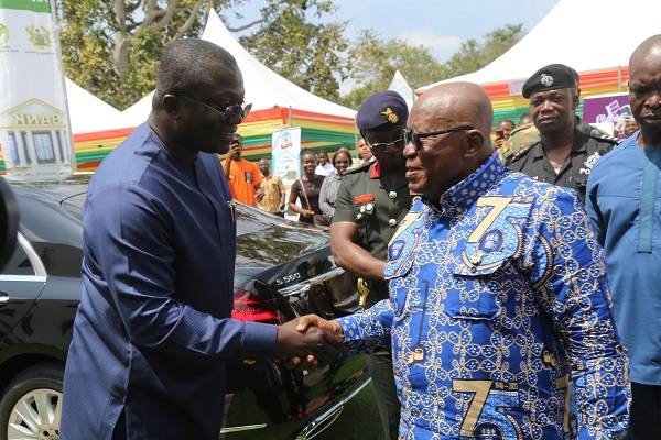 President Akufo-Addo (right) in a handshake with Dr Bryan Acheampong