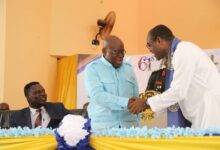 President Akufo-Addo in a hand shake with Rev Fr. Stephen Owusu Sekyere(right). With them is Dr Yaw Adutwum