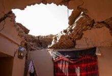 Cracked walls and a gaping hole in the ceiling of a house in Herat province
