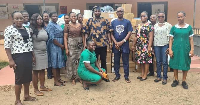 Mr Addae (fourth right) and DrTimbire (middle) with staff of the hospital by the items