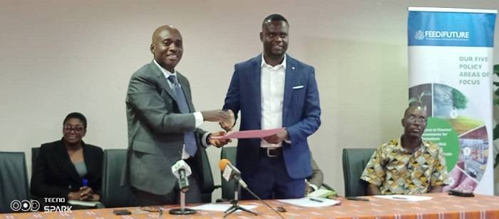 • Mr Andoh (left) exchanging the MoU document with Mr Abdulai
