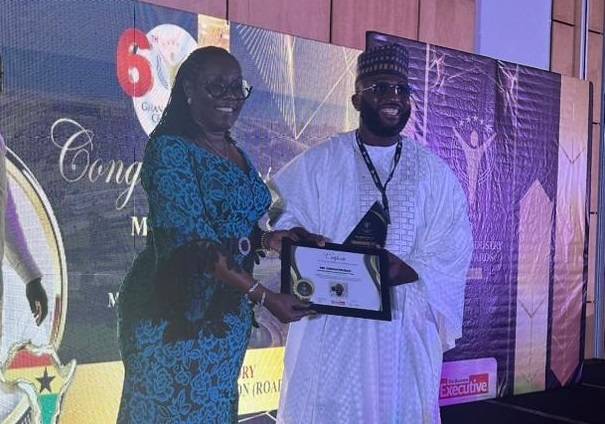 • Alhaji Osman receiving a certificate of honour from Mrs Usula Owusu Ekuful, Minister for Communications and Digitalisation