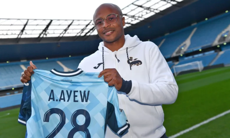 Andre Ayew displays his new team shirt and number