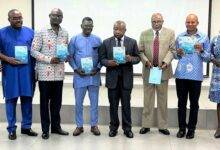• Mr Agyemang Manu (third from right) and other dignitaries with copies of the report