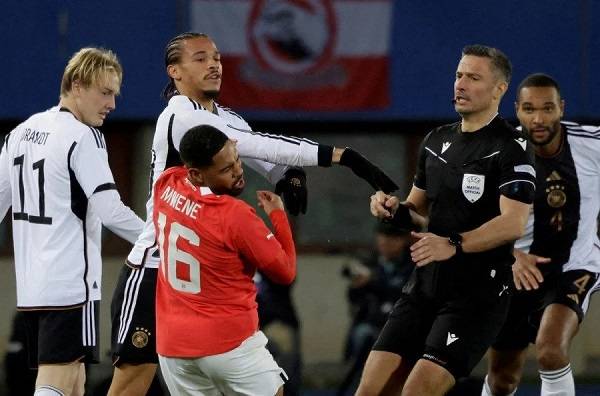 Germany's Leroy Sane clashes with Austria's Philip Mwene before he is shown a red card by referee Slavko Vincic.