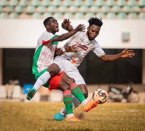 • Karela FC's Samuel Attah Kumi (left) and Dereick Afeson Boateng of Aduana Stars in a tussle for the ball
