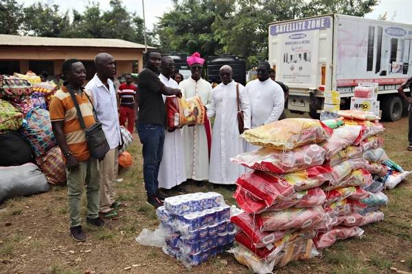 • Monsignor Twum Barimah handing over the items to the Assemblyman