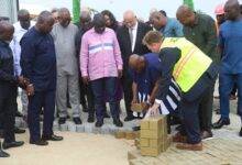 • President Akufo-Addo (second from right) about to lay a block to commence the Tema Port expansion project
