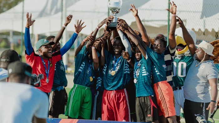 • Members of Nima 2 School hold aloft the trophy after the presentation
