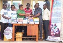 • Ms Garglo (third from left) presenting the items to Mr Amedonu (second from right)