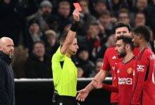 Ten Hag (left) watches as Rashford is shown the red card during the match