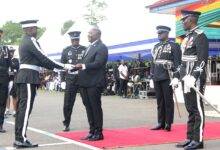 Vice President, Dr Mahamadu Bawumia (middle) presenting the overall best award to Frank Kwaku Fialor. With them include IGP George Akuffo Dampare (right)