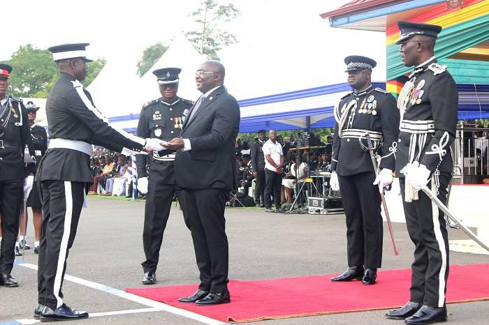 Vice President, Dr Mahamadu Bawumia (middle) presenting the overall best award to Frank Kwaku Fialor. With them include IGP George Akuffo Dampare (right)