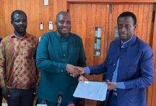 • Mr Agyemang (middle) presenting the report to Mr Darko-Mensah