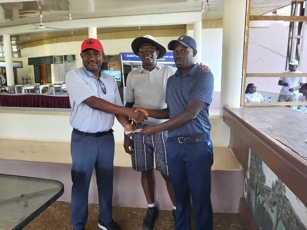 • Mr Roger Adama of Goldfields Ghana (left) supported by GGA President Leonard Okyere to present a cheque to Kojo Barnni (right)