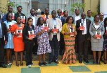 Dr Baffour Awuah (middle) with other dignitaries and participants with the report Photo Godwin Ofosu-Acheampong