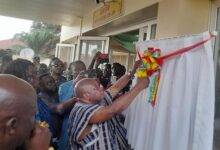 • Mr Kwaku Agyeman-Manu (in smock) cutting the tape to inaugurate the hospital