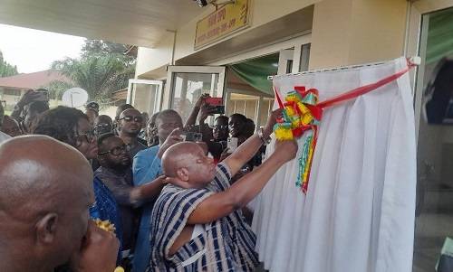 • Mr Kwaku Agyeman-Manu (in smock) cutting the tape to inaugurate the hospital