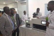 Dr Anthony Nsiah Asare (left) inspecting the equipment at the KOICA -KH lab.