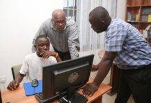 • Officials of Afriwave Telecom and an inmate of the Teshie Orphanage using one of the computers in the library
