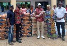 Mr Adjei (second from left) presenting the items to Mr Fenu (third from right)