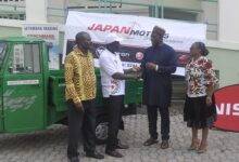 Mr Musah (second right) hand over one of the vehicles to Mr Addo (second left) while some officials of the two organisations look on.