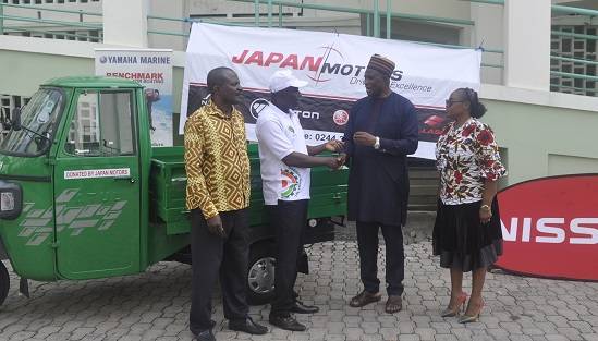 Mr Musah (second right) hand over one of the vehicles to Mr Addo (second left) while some officials of the two organisations look on.