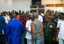 • Mr Dominic Nitiwul (left), and Mr Oppong Nkrumah (right) exchanging greetings with the senior military officers after the briefing