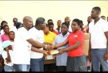 • Mr Ayeh (second from left) handing over the items to one of the pupils
