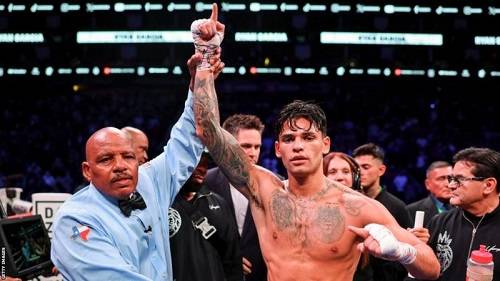 • Referee James Green hold high Ryan Garcia after the fight